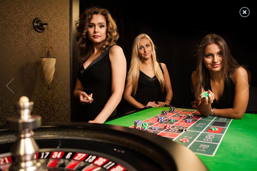 Live dealer hosts around a casino table.